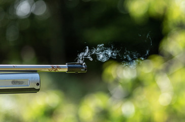 Gas coming out of the muzzle of a BB air pistol.