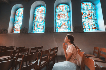 Asian woman praying in church