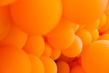 Festive composition with bunch of matte orange balloons. Macro shot, close up, background with a...