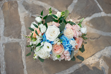 Bouquet of roses, hydrangeas, carnations, eustoma in on a concrete background, vintage style