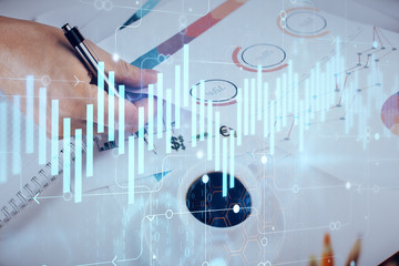 Multi exposure of man planing investment with stock market forex chart.
