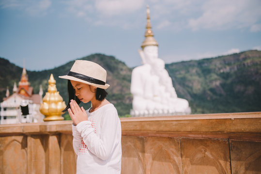 Asian woman Buddhists pay respect to the Buddha in temple.