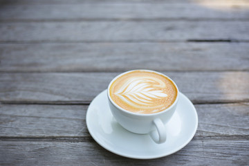 Coffee in white cup on old rustic wooden table