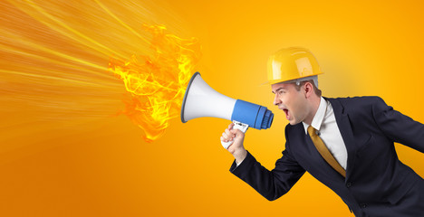 Fototapeta premium Young architect constructor yelling with megaphone with copyspace