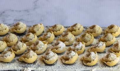 Tortellini on a dark board.