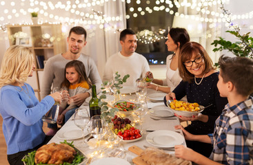 celebration, holidays and people concept - happy family having dinner party at home