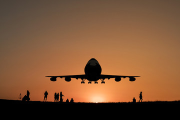 Fototapeta na wymiar big jet plane flying on sunset sky background.