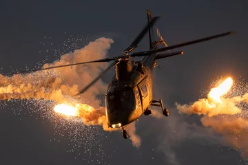 Fotobehang Militaire helikopter vuurt vuurpijlen af © VanderWolf Images