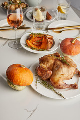 grilled turkey and baked pumpkins served on white marble table