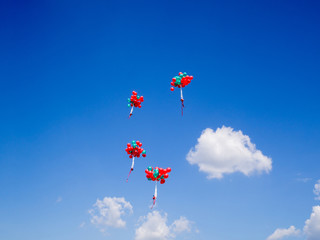 4 bundles of red and green balloons Float beautifully into the sky,  Free on holiday concept