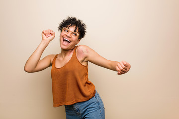 Young african american woman with skin birth mark dancing and having fun.