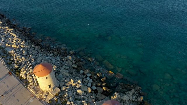 famous mills of the port of Mandraki in beautiful setting sun, Rhodes Greece, drone view