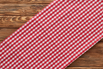 top view of red plaid napkin on wooden table