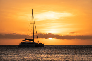 Sunset over two catamaran sailboat off the Yasawa island in Fiji