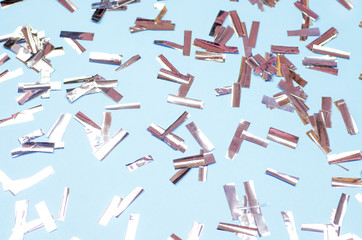 Christmas silver confetti on a blue background.