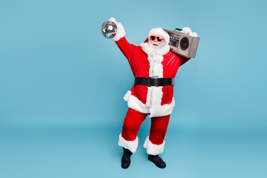 Full length body size view of his he nice cool fat cheerful cheery glad carefree bearded Santa carrying tape player dancing holding in hand discoball isolated on blue turquoise pastel color background