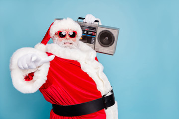 Fototapeta na wymiar Close-up pf his he nice cool fat cheerful cheery glad bearded Santa clubber carrying tape player pointing at you invite welcome to nightclub isolated on blue turquoise pastel color background
