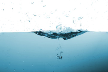 Water splash or water wave with bubbles of air on the background.