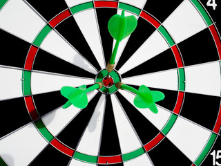 Target with three green dart focus on bull's eye, Setting challenging business goals And ready to...