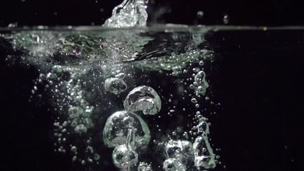 Onion splashing into water on black background closeup in super slow motion - Powered by Adobe