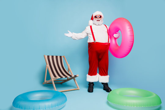 Full length body size view of his he nice glad cheerful fat overweight bearded Santa traveler at poolside party having fun day isolated over blue turquoise pastel color background