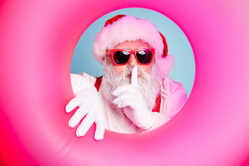 Close-up portrait of his he nice attractive mysterious bearded Santa in inflatable circle showing...