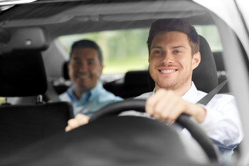 transport, people and taxi concept - happy smiling male driver driving car with passenger
