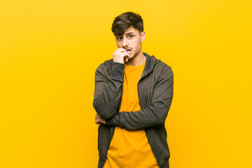 Fototapeta premium Young hispanic casual man relaxed thinking about something looking at a copy space.