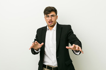 Young business hispanic man being shocked due to an imminent danger