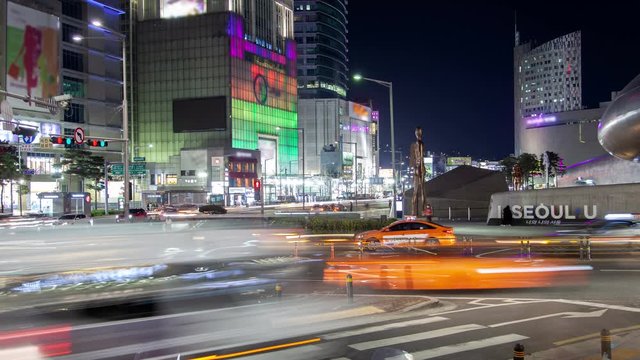 SEOUL/KOREA - MAY 29 2019: Timelapse commercial Dongdaemun district with markets and shopping centers flashing advertisement illumination in Seoul city at night zoom in on May 29 in Seoul