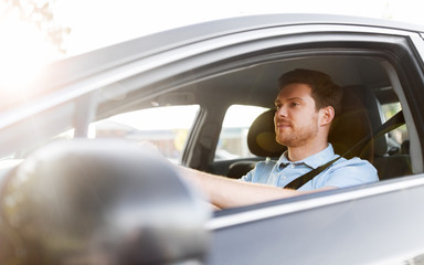 transport, vehicle and people concept - man or driver driving car in summer