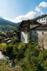 Fototapeta na wymiar picturesque mountain village with white stone houses and stone roofs in the Swiss Alps