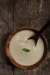 Homemade Tahini Sauce / Paste -Middle Eastern Dip in a wooden bowl, top view