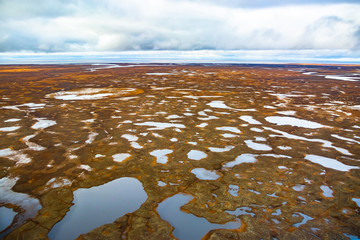Photographing from a helicopter in the Arctic. Autumn nature landscape of the northern tundra. The...