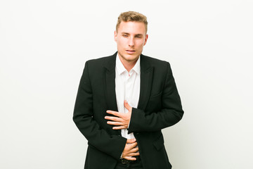 Young caucasian business man sick, suffering from stomachache, painful disease concept.