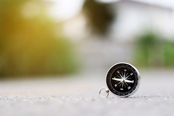 A compass on road texture background, journey of life concept