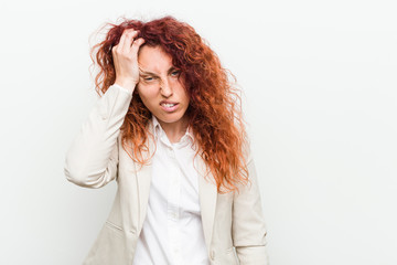 Naklejka premium Young natural redhead business woman isolated against white background tired and very sleepy keeping hand on head.