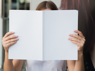 Woman holding a mock-up magazine