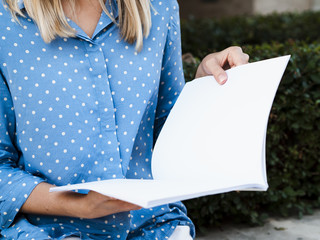 Close-up woman reading a mock-up magazine