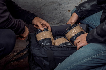 A person with money buys a dose of cocaine or heroin or other drug from a drug dealer