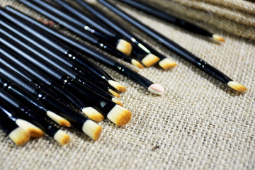 Several brush for makeup, put on sackcloth.