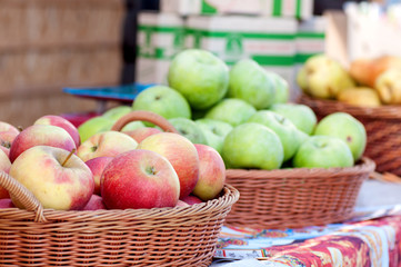 red ripe apples in a basket at the market