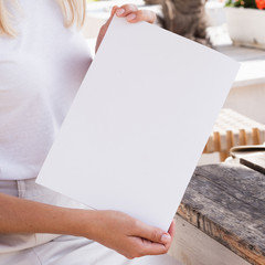 Close-up woman holding a mock-up magazine