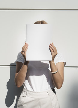 Woman holding a mock-up magazine