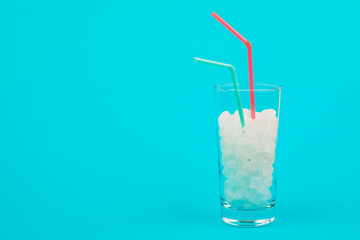 Glass of sugar. The concept of junk food. On red background.