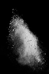 White powder splash isolated on black background. Flour sifting on a black background. Explosive powder white