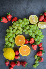 Colorful fruits and berries, on dark background