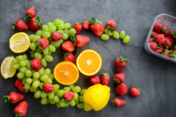 Colorful fruits and berries, on dark background