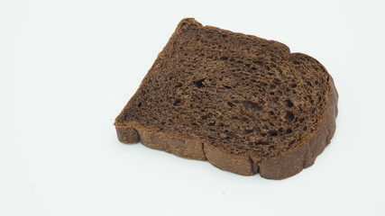 Dark cocoa bread on white background. It is a natural whole grain.