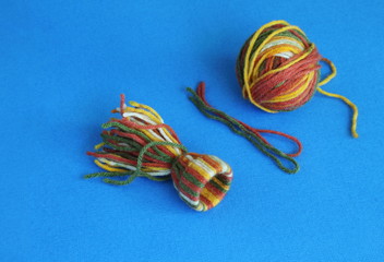 Homemade Christmas toy. Step 4. After filling paper base, tighten and fasten thread, form hat. Concept - Christmas, New Year, crafts, hobbies.